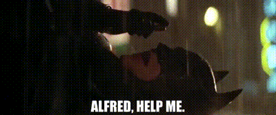 A GIF of Batman calling for help. Lying on the ground, raindrops exploding off his suit, he's certainly seen better days. He's thrown himself out of a window after being gassed, showered in gasoline, and lit on fire. In his time of need, he calls the one person he can trust: "Alfred, HELP ME!!“